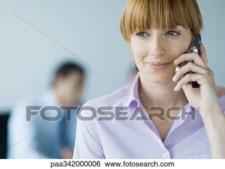 Businesswoman using cell phone View Large Photo Image Stock Photograph - Businesswoman using cell phone. Fotosearch