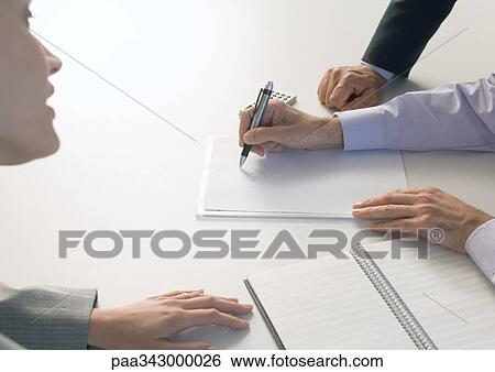 Stock Photograph - Businesspeople signing document. Fotosearch