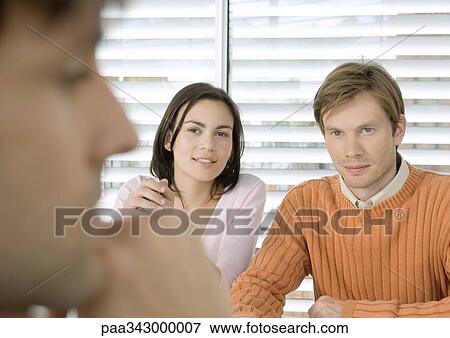 Couple having meeting with businessman View Large Photo Image Stock Photo - Couple having meeting with businessman. Fotosearch