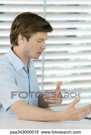 Man gesturing, side view View Large Photo Image Stock Photo - Man gesturing, side view. Fotosearch
