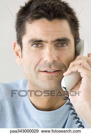 Man using phone View Large Photo Image Stock Photo - Man using phone. Fotosearch
