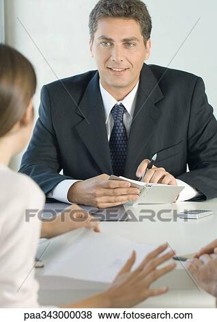 Sales executive listening to customer View Large Photo Image Stock Photo - Sales executive listening to customer. Fotosearch