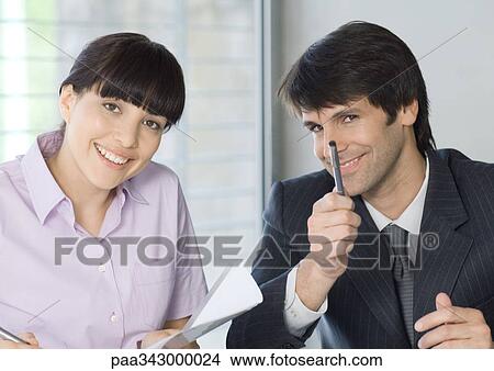 Two business colleagues smiling at camera View Large Photo Image Picture - Two business colleagues smiling at camera. Fotosearch