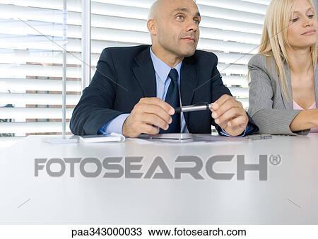 Two business executives listening during meeting View Large Photo Image Stock Image - Two business executives listening during meeting. Fotosearch