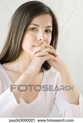 Woman with hands clasped in front of mouth View Large Photo Image Stock Image - Woman with hands clasped in front of mouth. Fotosearch