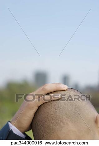 Businessman holding head, cropped View Large Photo Image Stock Photograph - Businessman holding head, cropped. Fotosearch