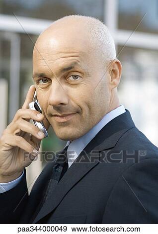 Businessman using cell phone View Large Photo Image Stock Photo - Businessman using cell phone. Fotosearch