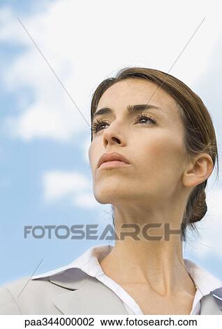 Woman looking into distance, portrait, low angle view View Large Photo Image Stock Image - Woman looking into distance, portrait, low angle view. Fotosearch
