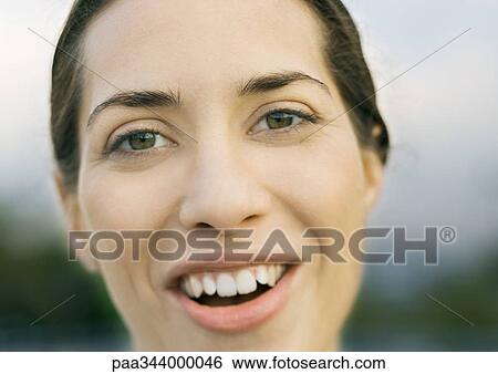 Woman's face, smiling at camera View Large Photo Image Stock Photograph - Woman's face, smiling at camera. Fotosearch