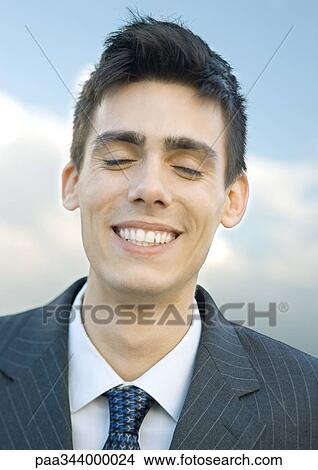 Young businessman, eyes closed, portrait View Large Photo Image Picture - Young businessman, eyes closed, portrait. Fotosearch