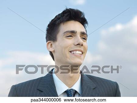 Stock Photograph - Young businessman smiling, portrait. Fotosearch