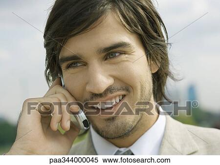 Young businessman using cell phone View Large Photo Image Stock Photography - Young businessman using cell phone. Fotosearch