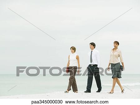 Business team walking on beach View Large Photo Image Stock Image - Business team walking on beach. Fotosearch