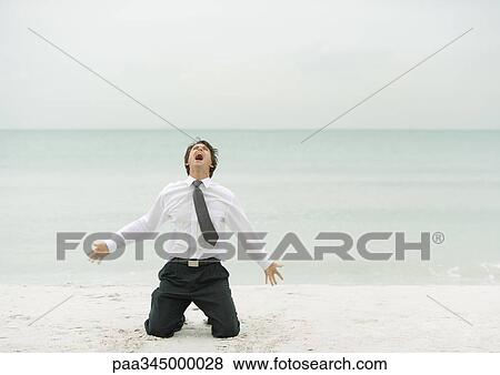 Businessman down on knees, screaming, on beach View Large Photo Image Stock Photo - Businessman down on knees, screaming, on beach. Fotosearch
