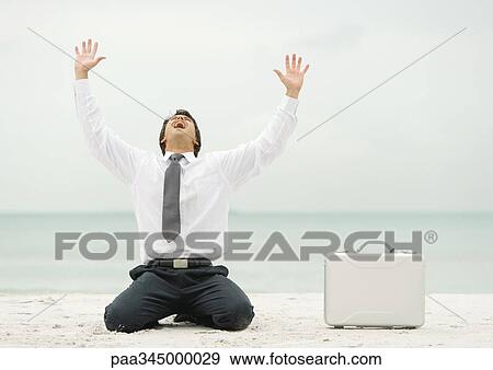 Businessman down on knees, shouting, on beach View Large Photo Image Stock Photo - Businessman down on knees, shouting, on beach. Fotosearch