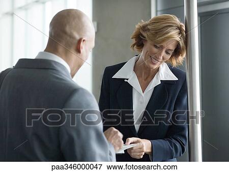 Stock Photo - Airline attendent taking businessman's ticket. Fotosearch