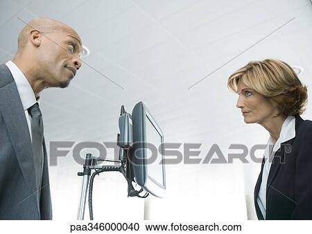 Businessman and female airline attendant staring at each other View Large Photo Image Stock Image - Businessman and female airline attendant staring at each other. Fotosearch