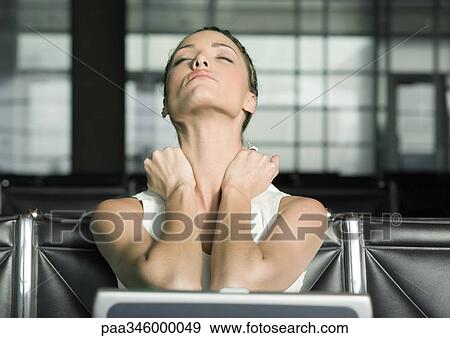 Female traveler stretching neck and closing eyes View Large Photo Image Stock Photo - Female traveler stretching neck and closing eyes. Fotosearch