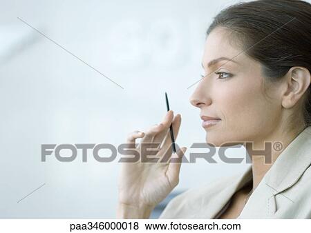 Woman holding up stylus, side view View Large Photo Image Stock Photo - Woman holding up stylus, side view. Fotosearch