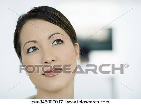 Stock Photo - Woman looking away, close-up of face. Fotosearch