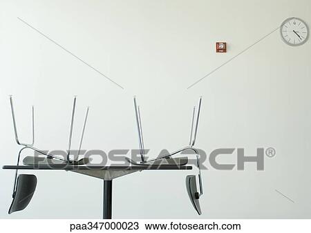 Chairs upside down on table in breakroom View Large Photo Image Stock Image - Chairs upside down on table in breakroom. Fotosearch