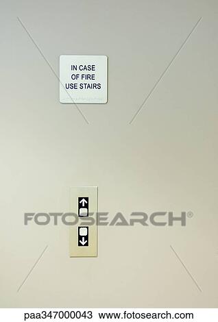 Stock Image - Elevator call buttons and warning sign. Fotosearch