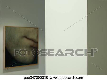 Stock Photo - Framed photo of face hanging on wall. Fotosearch