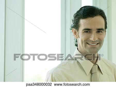 Businessman smiling, portrait View Large Photo Image Stock Image - Businessman smiling, portrait. Fotosearch