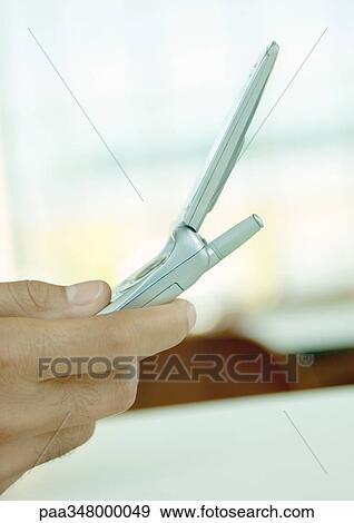 Hand holding cell phone, extreme close-up View Large Photo Image Stock Photo - Hand holding cell phone, extreme close-up. Fotosearch