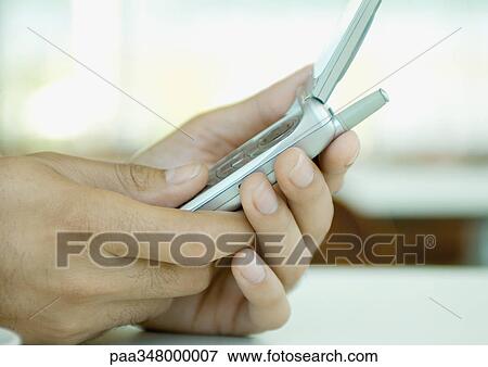 Stock Photo - Hands holding cell phone. Fotosearch