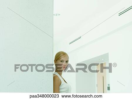 Woman standing in hallway of office building View Large Photo Image Stock Image - Woman standing in hallway of office building. Fotosearch