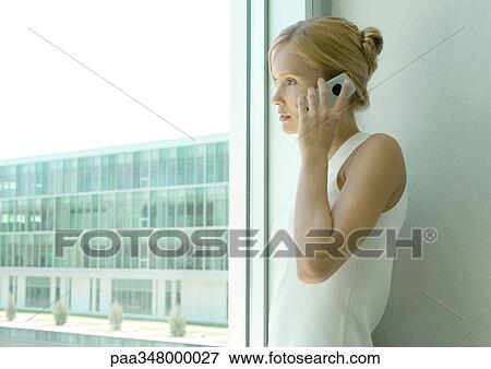 Stock Photo - Woman using cell phone. Fotosearch