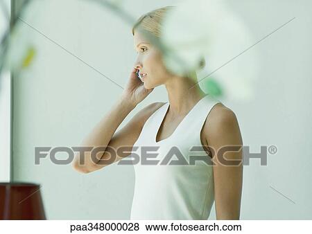 Woman using cell phone View Large Photo Image Stock Photo - Woman using cell phone. Fotosearch