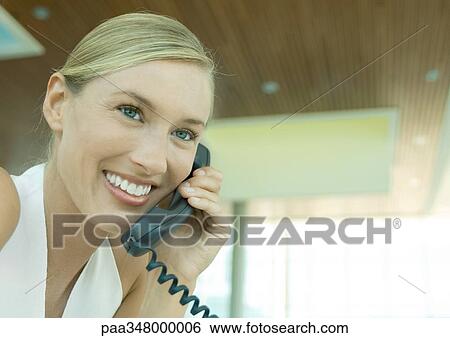 Stock Photograph - Woman using telephone. Fotosearch