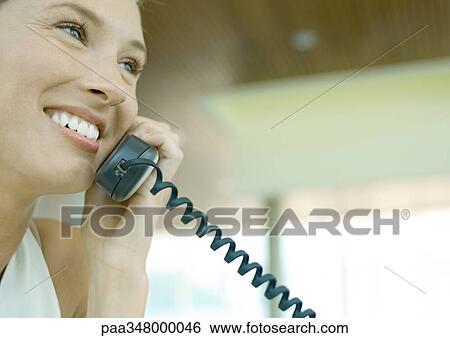 Stock Photograph - Woman using telephone. Fotosearch