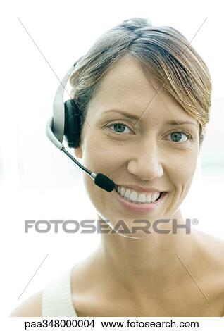 Picture - Woman wearing headset. Fotosearch
