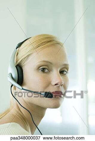 Stock Photo - Woman wearing headset. Fotosearch