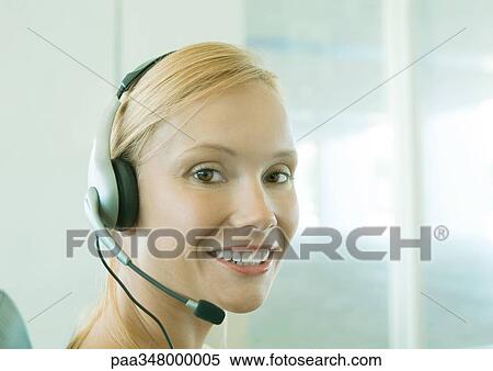 Stock Photography - Woman wearing headset. Fotosearch