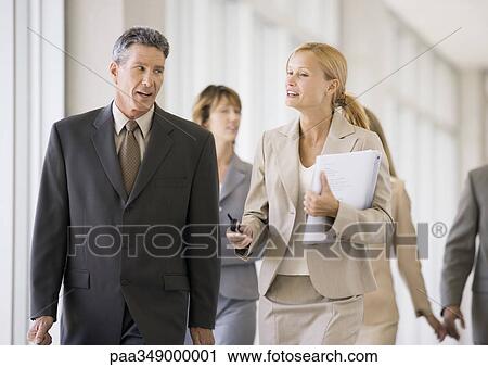 Group of business executives walking through corridor View Large Photo Image Stock Image - Group of business executives walking through corridor. Fotosearch