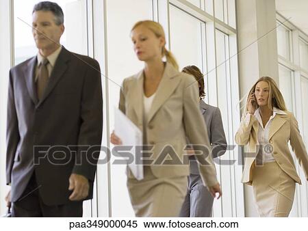 Group of business executives walking through corridor View Large Photo Image Stock Photography - Group of business executives walking through corridor. Fotosearch