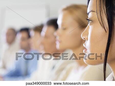 Group of executives in meeting, side view, focus on woman in foreground View Large Photo Image Stock Image - Group of executives in meeting, side view, focus on woman in foreground. Fotosearch