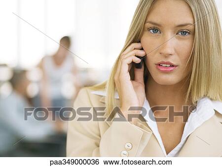 Young businesswoman using cell phone View Large Photo Image Stock Photograph - Young businesswoman using cell phone. Fotosearch
