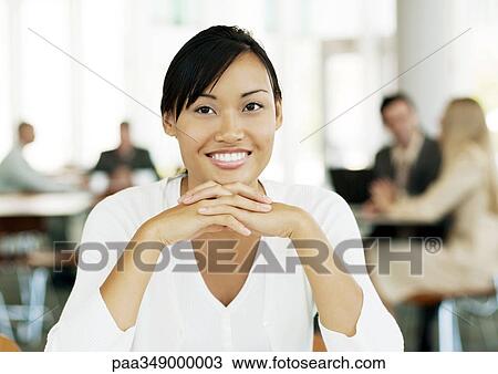 Young female office worker smiling View Large Photo Image Stock Image - Young female office worker smiling. Fotosearch