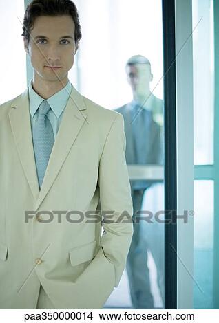 Businessman standing in front of door View Large Photo Image Picture - Businessman standing in front of door. Fotosearch
