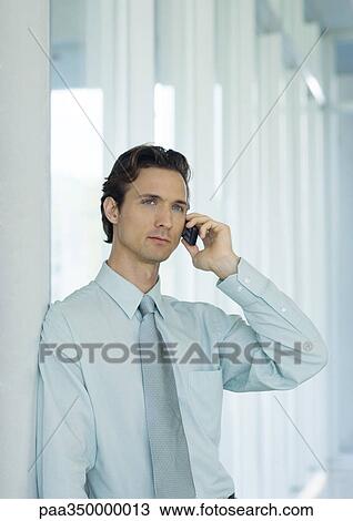 Businessman using cell phone View Large Photo Image Stock Image - Businessman using cell phone. Fotosearch