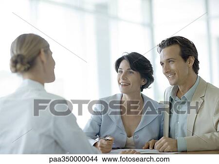 Couple standing at reception desk View Large Photo Image Picture - Couple standing at reception desk. Fotosearch