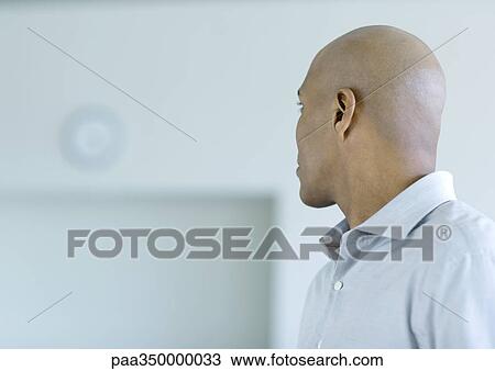 Stock Image - Man looking at clock. Fotosearch