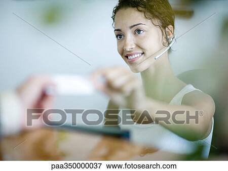 Receptionist handing card to customer View Large Photo Image Stock Photo - Receptionist handing card to customer. Fotosearch