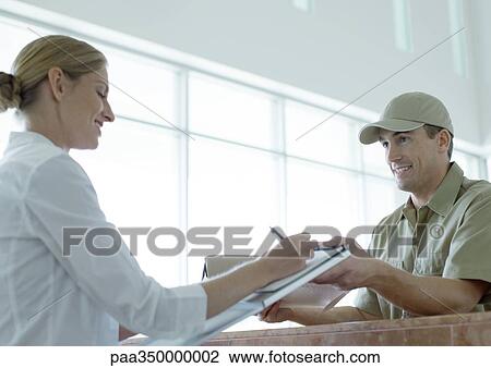 Receptionist signing for delivery View Large Photo Image Stock Image - Receptionist signing for delivery. Fotosearch