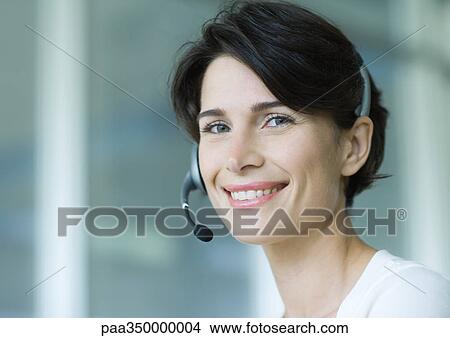 Picture - Woman wearing headset and smiling. Fotosearch